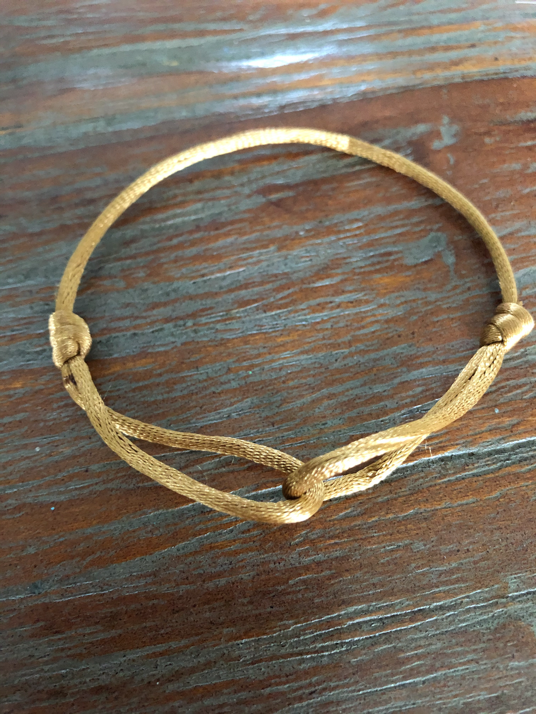 Satijnkoord armbandje Goudkleur